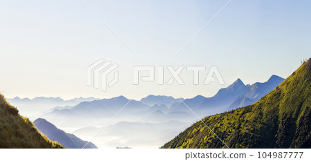Wide panorama of morning mountain hills. Carpathian mountains at sunrise. 104987777