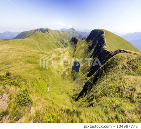 Wide panorama of green mountain hills. Carpathian mountains in summer. 104987778
