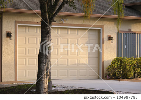 Wide garage double door and concrete driveway of new modern american house 104987783