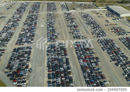 View from above of big parking lot with parked used cars after accident ready for sale. Auction reseller company selling secondhand broken vehicles for repair View from above of big parking lot with parked used cars after accident ready for sale. Auction reseller company selling secondhand broken vehicles for repair 104987895