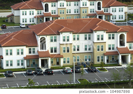 View from above of apartment residential condos in Florida suburban area. American condominiums as example of real estate development in USA suburbs View from above of apartment residential condos in Florida suburban area. American condominiums as example of real estate development in USA suburbs 104987898