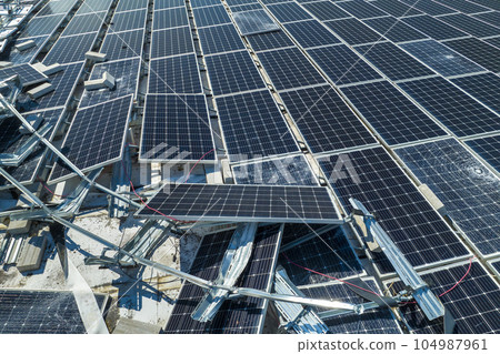 Top view of destroyed by hurricane Ian photovoltaic solar panels mounted on industrial building roof for producing green ecological electricity. Consequences of natural disaster in Florida Top view of destroyed by hurricane Ian photovoltaic solar panels mounted on industrial building roof for producing green ecological electricity. Consequences of natural disaster in Florida 104987961