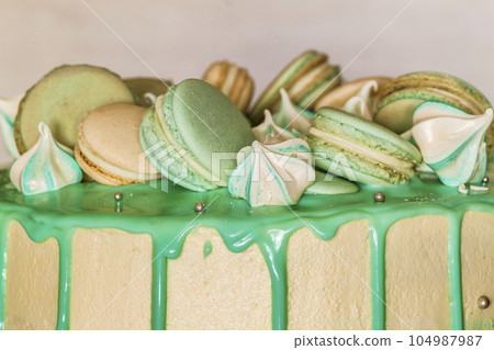 Sweet creamy green cake with macaroons on top 104987987