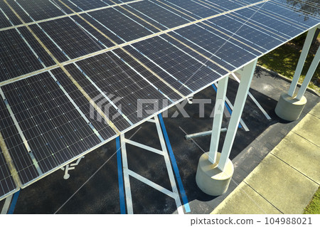 Solar panels installed over parking lot for parked cars for effective generation of clean energy Solar panels installed over parking lot for parked cars for effective generation of clean energy 104988021