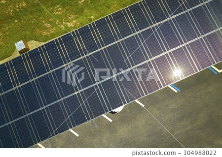 Solar panels installed over parking lot for parked cars for effective generation of clean energy Solar panels installed over parking lot for parked cars for effective generation of clean energy 104988022