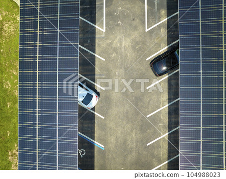 Solar panels installed over parking lot for parked cars for effective generation of clean energy 104988023