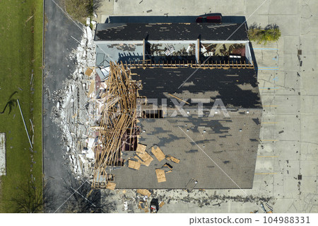 Natural disaster and its consequences. Hurricane Ian destroyed house roof and walls in Florida residential area 104988331