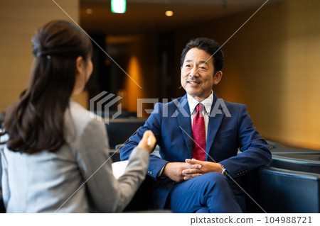 Executive man being interviewed Executive man being interviewed 104988721