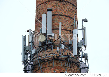 Closeup and detailed view of various GPS, cellphone, 3G, 4G and 5G equipped telecommunication tower 104989180