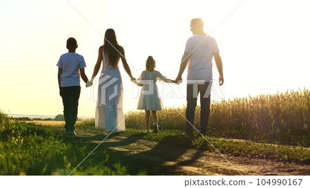 mother father child daughter son walk sunset, holding hands parents girl boy. happy family, wheat field, childhood dream, green garden, love for children, happy family and little child holding hands mother father child daughter son walk sunset, holding hands parents girl boy. happy family, wheat field, childhood dream, green garden, love for children, happy family and little child holding hands 104990167