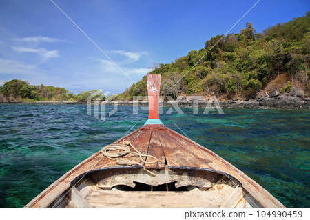 wooden boat sail on turquoise Andaman to snorkel at Ko Lipe wooden boat sail on turquoise Andaman to snorkel at Ko Lipe 104990459