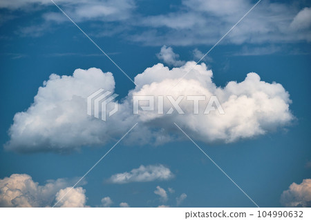 Bright landscape of white puffy cumulus clouds on blue clear sky. Bright landscape of white puffy cumulus clouds on blue clear sky. 104990632