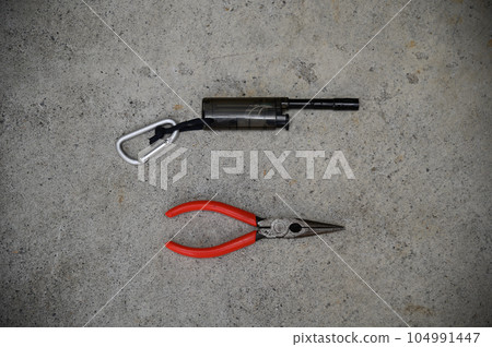 Needle-nose pliers and a lighter with a long nozzle useful for camping 104991447