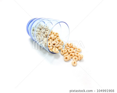 Isolated of cereal pour from the blue glass 104991908