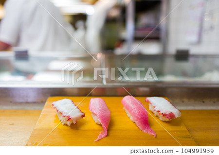 Closeup of sushi on wooden plate in japanese restuarant 104991939