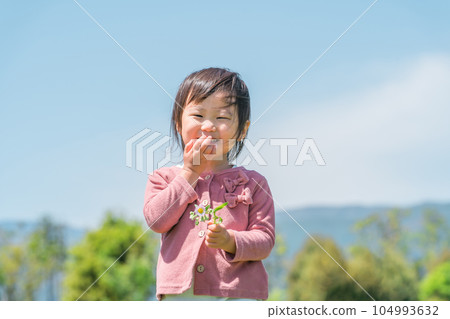 Child (girl) playing picking flowers Child (girl) playing picking flowers 104993632