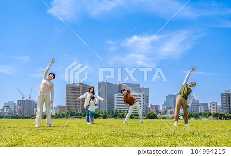 Three generations of families doing gymnastics in the park Three generations of families doing gymnastics in the park 104994215