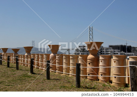 View of the Akashi Kaikyo Bridge from the Goshikizuka Tumulus through earthenware View of the Akashi Kaikyo Bridge from the Goshikizuka Tumulus through earthenware 104994453