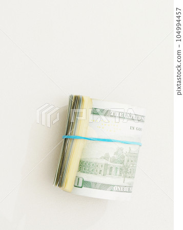 Rolled up dollar bills on a white background. Rolled up dollar bills on a white background. 104994457