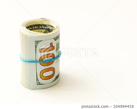 Rolled up dollar bills on a white background. 104994458