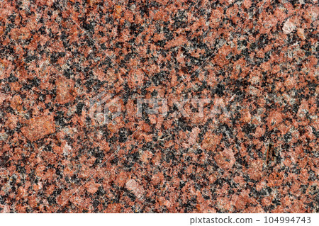 The texture of the granite stone surface in close-up. 104994743