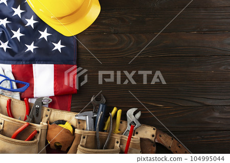 Tools hardhat toolbelt and us flag on wooden background labor day banner mockup Tools hardhat toolbelt and us flag on wooden background labor day banner mockup 104995044