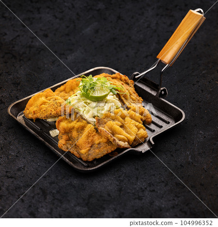 Veal schnitzel as main dish Veal schnitzel as main dish 104996352