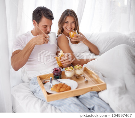 Breakfast, bed and couple portrait with love, care and morning food together at home. Happiness, smile and relax young people eating and drinking in a house for anniversary or valentines day Breakfast, bed and couple portrait with love, care and morning food together at home. Happiness, smile and relax young people eating and drinking in a house for anniversary or valentines day 104997467