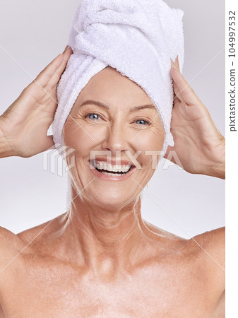 Portrait, senior or happy woman with beauty, towel or smile in studio isolated on white background. Dermatology, face or mature lady with natural facial skincare cosmetics or glowing shine in spa 104997532