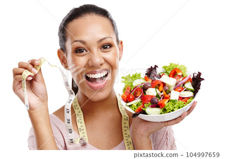 Diet, measuring tape and portrait of woman with salad for health, wellness and lose weight nutrition lifestyle. Smile of happy black woman with healthy food on isolated white background. Diet, measuring tape and portrait of woman with salad for health, wellness and lose weight nutrition lifestyle. Smile of happy black woman with healthy food on isolated white background. 104997659