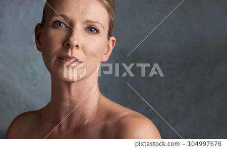 Mature woman, skin care and portrait with natural beauty and cosmetic dermatology. Isolated, gray background and female person face with facial treatment and mock up with anti aging cosmetics Mature woman, skin care and portrait with natural beauty and cosmetic dermatology. Isolated, gray background and female person face with facial treatment and mock up with anti aging cosmetics 104997676