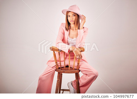 Fashion, portrait and serious woman on chair in studio isolated on a white background mockup space. Confident, stylish and female model from Brazil with cool designer clothes, pink hat and aesthetic. Fashion, portrait and serious woman on chair in studio isolated on a white background mockup space. Confident, stylish and female model from Brazil with cool designer clothes, pink hat and aesthetic. 104997677