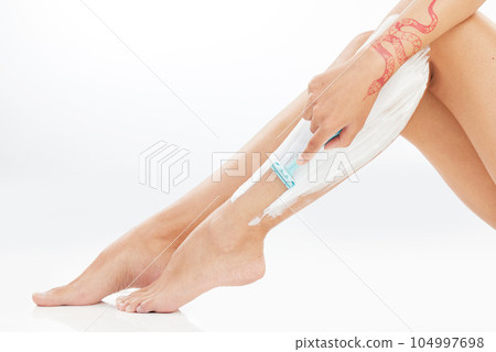 Be patient. Your skin took a while to deteriorate. Studio shot of an unrecognizable young woman shaving her legs against a white background. 104997698