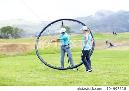 Ring, sports woman or golfer in golf course lesson for fitness, workout or exercise with a swing on field. Coaching, golfing game or athlete training with instructor for driving with a club stroke Ring, sports woman or golfer in golf course lesson for fitness, workout or exercise with a swing on field. Coaching, golfing game or athlete training with instructor for driving with a club stroke 104997816
