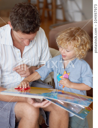 Man with boy child, reading book for education and development, spending quality time together at home. Family, teaching and learning with father and kid bonding, picture story with toys for growth 104997973