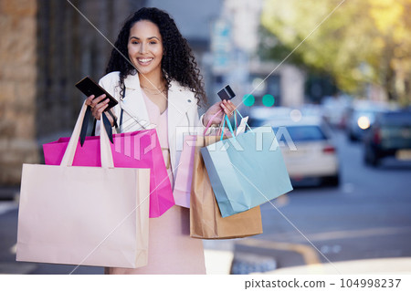 Shopping bag, phone and credit card with portrait of woman in city for payment, fintech or ecommerce app. Fashion, retail and finance with female customer in street for luxury, sale or online banking Shopping bag, phone and credit card with portrait of woman in city for payment, fintech or ecommerce app. Fashion, retail and finance with female customer in street for luxury, sale or online banking 104998237