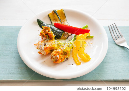 zucchini flowers stuffed with minced meat 104998302