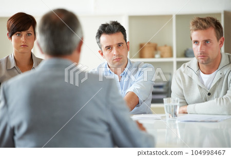 Serious, meeting and business people in discussion in the office for human resources problem. Collaboration, team and group of professional employees talking on corporate hr issue in modern workplace 104998467