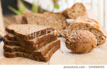 fresh loaf of bread on wooden board 104998493