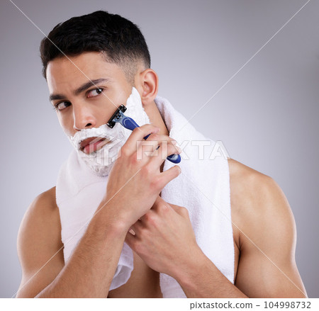 Beauty, shaving and foam with man in studio for hair removal, grooming and skincare. Cosmetics, self care and shower with face of male model on gray background for cleaning, razor blade and product 104998732