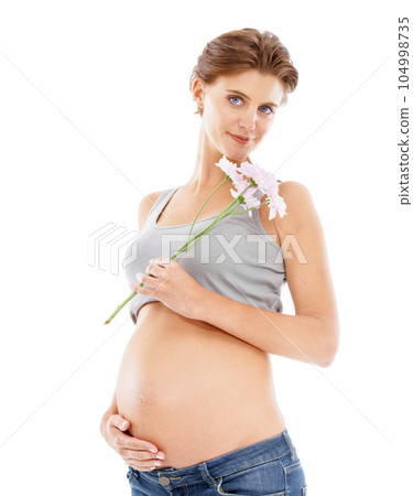 Flowers, pregnant woman and studio portrait for pregnancy skincare, cellulite and beauty cosmetics. Healthcare, wellness and mother hand on stomach with floral or natural product advertising 104998735