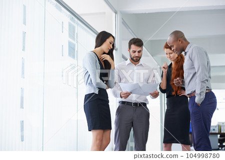 Team work, businesspeople and discussing paperwork or budget and meeting in office. Project, planning and business gathering for brainstorm with colleagues or company financial or management 104998780