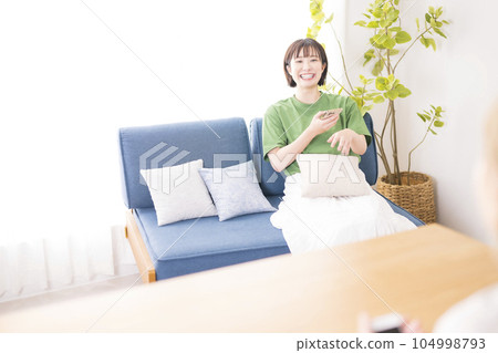 two women sitting on the sofa two women sitting on the sofa 104998793