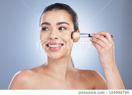 Makeup, brush and happy asian woman studio with cheek tool, cosmetics and application on grey background. Face, smile and lady wellness model with beauty, glamour or contour, results or cover routine 104998799