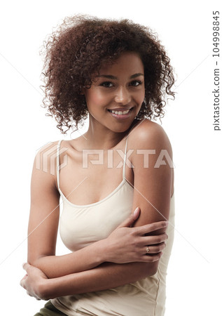 Beauty, skincare and portrait of African woman on white background with trendy, stylish and casual clothes. Natural makeup, wellness and face of beautiful, attractive and happy female model in studio Beauty, skincare and portrait of African woman on white background with trendy, stylish and casual clothes. Natural makeup, wellness and face of beautiful, attractive and happy female model in studio 104998845