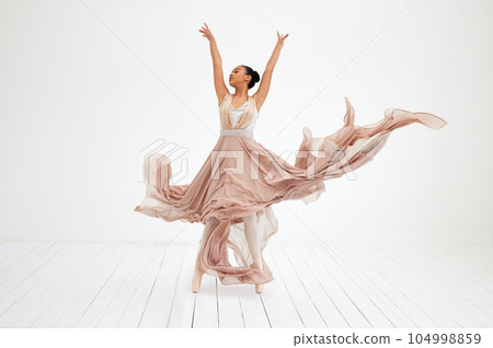 Nothing but dance. Full length shot of an attractive young female ballerina practicing in her dance studio. 104998859