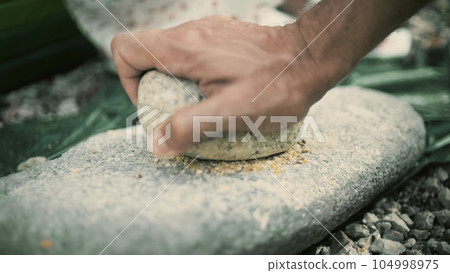 Making bread flour in a primitive historic way Making bread flour in a primitive historic way 104998975