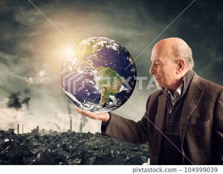 Old man saves the world from pollution. Earth provided by Nasa 104999039