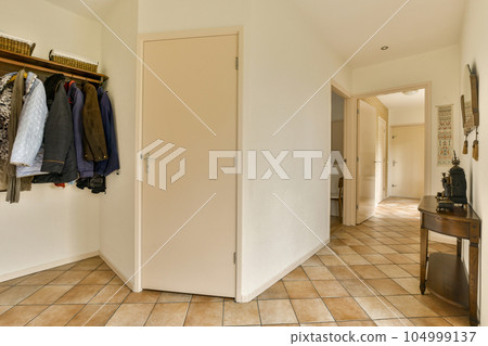the inside of a room with clothes hanging on hooks and closets in it, as well to be used 104999137