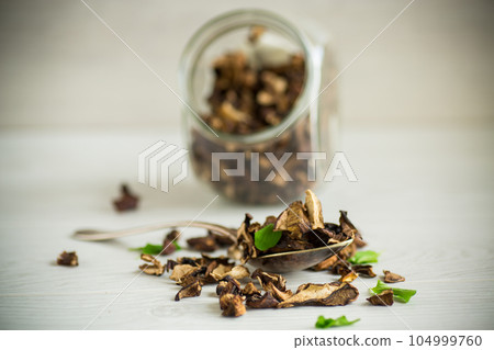 dried forest edible mushrooms on wooden table dried forest edible mushrooms on wooden table 104999760